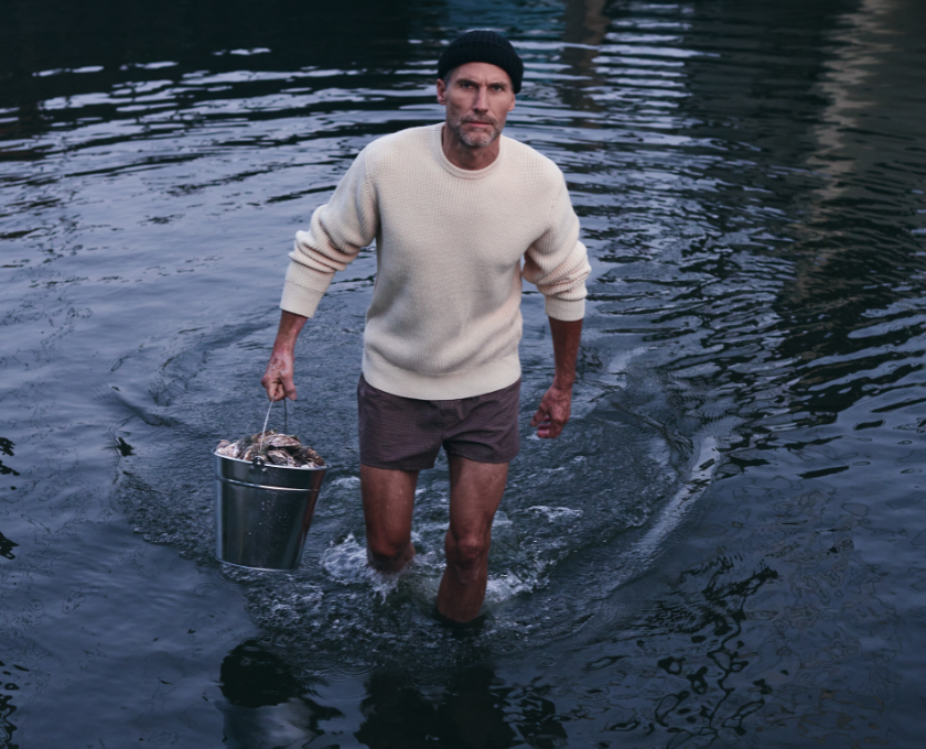 Man emerging from sea wearing a LABFRESH seawool sweater.